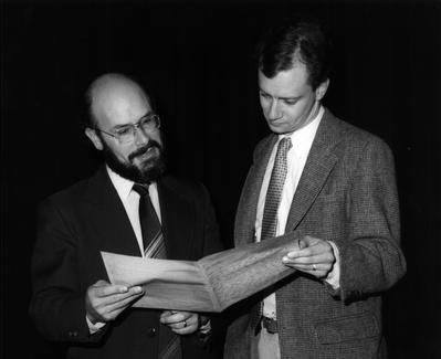 [two gentlemen looking at a letter]