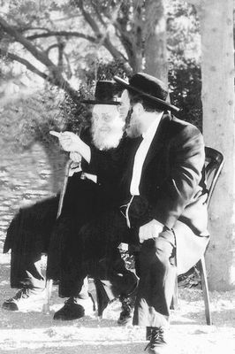 two gentlemen sitting on bench