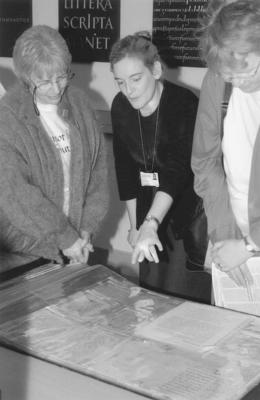 three people and manuscripts